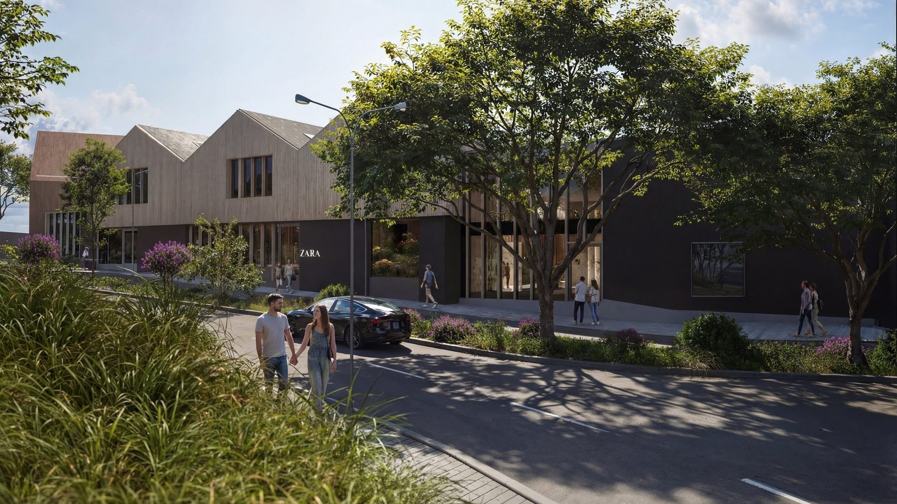 Tree-lined street at Halo Village with timber-clad gabled shops and people walking past
